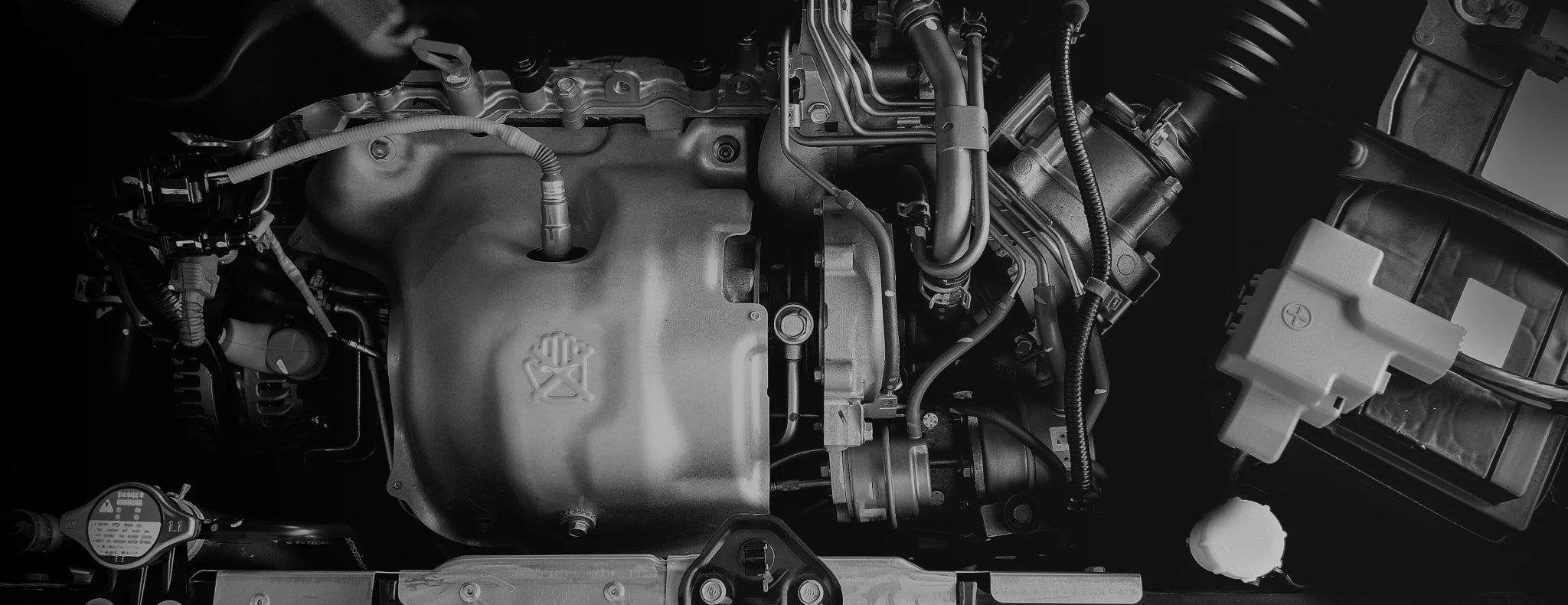 Close-up of a car engine with visible components.