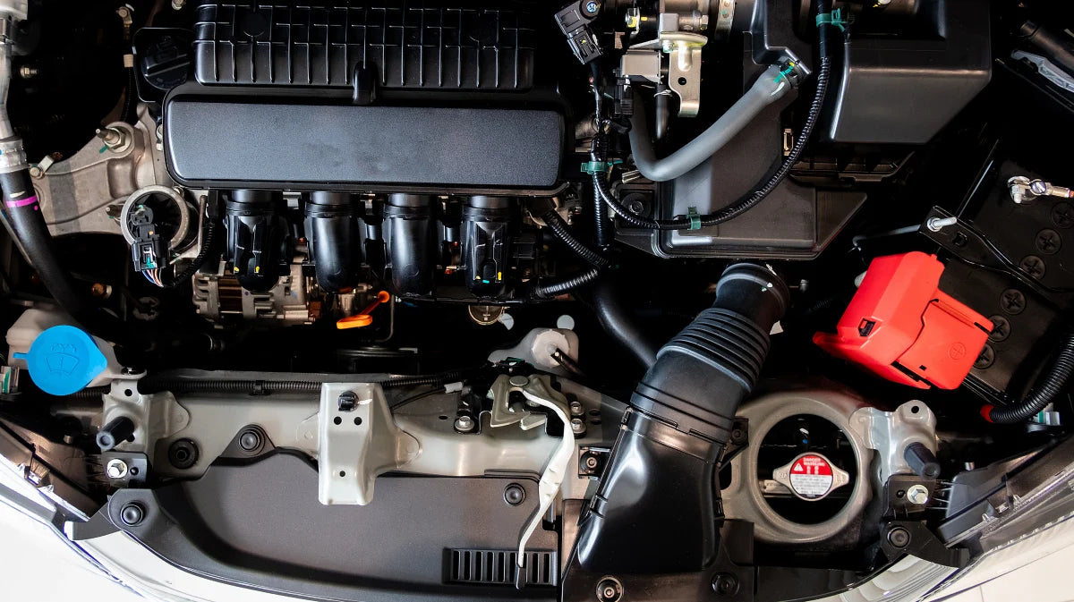 Car engine compartment with various components visible