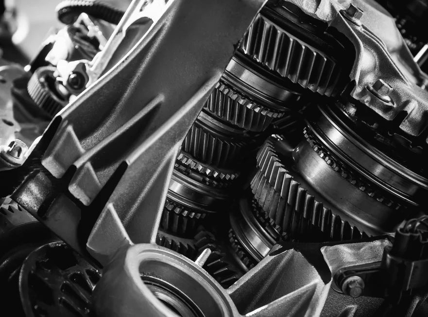 Close-up of mechanical gears and components in black and white.